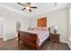 Light-filled main bedroom featuring tray ceiling, hardwood floors, and ensuite bathroom entrance at 4160 Grandview Vista St, Cumming, GA 30028
