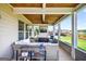 Relaxing screened-in porch with plenty of seating and an outdoor ceiling fan at 4160 Grandview Vista St, Cumming, GA 30028