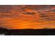 Vibrant sunrise with bright orange clouds stretching across the sky over a treed horizon at 4160 Grandview Vista St, Cumming, GA 30028