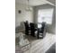 Contemporary dining area with a sleek black table, chairs, and modern chandelier at 2511 Pine Tree Trail, Atlanta, GA 30349