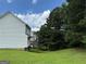 Exterior view of the home's back side showing the deck and lush green lawn at 133 Magazine St, Dallas, GA 30157