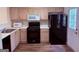 Functional kitchen with oak cabinets, black appliances, and durable countertops at 133 Magazine St, Dallas, GA 30157