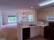 Open-concept kitchen with oak cabinets, a peninsula, and a view into the living area at 133 Magazine St, Dallas, GA 30157