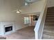 Bright living room featuring a fireplace, high ceilings, and staircase to the second level at 133 Magazine St, Dallas, GA 30157