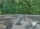 Relaxing back deck features outdoor seating and is surrounded by lush trees for privacy at 183 Eagles Club Dr, Stockbridge, GA 30281