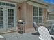 A back porch features a grill, furniture, windows, and glass patio doors to the interior of the house at 183 Eagles Club Dr, Stockbridge, GA 30281