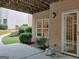 Backyard patio with lush landscaping, a covered area, and a walk-out basement entrance at 183 Eagles Club Dr, Stockbridge, GA 30281