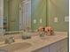 This bathroom is bright with double sinks, white cabinets and a large mirror at 183 Eagles Club Dr, Stockbridge, GA 30281