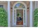 Inviting front entrance with decorative glass, sidelights, and elegant columns, opening to a bright interior at 183 Eagles Club Dr, Stockbridge, GA 30281