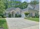 Charming single-story home featuring a well-manicured lawn, inviting entrance, and a spacious driveway at 183 Eagles Club Dr, Stockbridge, GA 30281