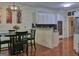 This eat-in kitchen features updated appliances, white cabinets, granite countertops and hardwood floors at 183 Eagles Club Dr, Stockbridge, GA 30281