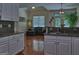 Kitchen features include white cabinetry, hardwood floors, and granite countertops with a view to the living room at 183 Eagles Club Dr, Stockbridge, GA 30281