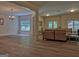 Open living room with hardwood floors, neutral walls, and a decorative chandelier at 183 Eagles Club Dr, Stockbridge, GA 30281