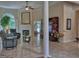 Spacious living room with a fireplace, marble floors, large windows, and stylish furniture, creating a comfortable space at 183 Eagles Club Dr, Stockbridge, GA 30281