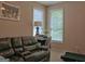 Cozy living room with leather reclining sofa, desk by window and unique artwork at 183 Eagles Club Dr, Stockbridge, GA 30281
