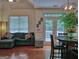 Comfortable living area with a cozy sectional, dining table, and access to the outdoor patio through glass doors at 183 Eagles Club Dr, Stockbridge, GA 30281