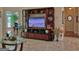 Living room featuring a custom entertainment center, neutral decor, and seamless flow to adjoining spaces at 183 Eagles Club Dr, Stockbridge, GA 30281