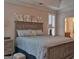 This main bedroom is spacious with hardwood floors and plantation shutters for natural light at 183 Eagles Club Dr, Stockbridge, GA 30281