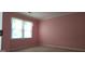 Compact bedroom featuring light-colored carpet, a window, and pink walls at 3626 Lone Indian Trl, Marietta, GA 30066