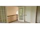 Bright second-story landing area with a set of french doors, a closet, and wood railings at 3626 Lone Indian Trl, Marietta, GA 30066