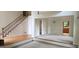 Bright living room featuring white trim, wood flooring, large staircase, and entry to the dining area at 3626 Lone Indian Trl, Marietta, GA 30066