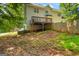 A backyard with a wooden deck, wooden fence, and sparse grass at 1048 Falls Brooke Dr, Conyers, GA 30094