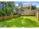 Backyard featuring a well-maintained lawn, wooden fence, and a deck, great for entertaining at 1048 Falls Brooke Dr, Conyers, GA 30094