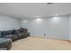 Finished basement featuring tile flooring, recessed lighting, and a comfortable gray sectional sofa at 1048 Falls Brooke Dr, Conyers, GA 30094