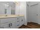 Bathroom features double sinks, a large mirror, and white cabinets at 1048 Falls Brooke Dr, Conyers, GA 30094