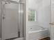 Bright bathroom with shower and tub at 1048 Falls Brooke Dr, Conyers, GA 30094