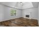 Bright bedroom features updated floors, fireplace, trey ceilings, and ceiling fan at 1048 Falls Brooke Dr, Conyers, GA 30094