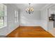 Formal dining room showcases elegant wainscoting and a classic chandelier, perfect for entertaining guests at 1048 Falls Brooke Dr, Conyers, GA 30094