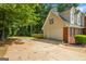 Side view of a brick and siding home with an attached garage and large driveway at 1048 Falls Brooke Dr, Conyers, GA 30094