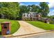 Beautiful two-story brick home with manicured lawn, driveway, and mature trees at 1048 Falls Brooke Dr, Conyers, GA 30094