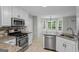 Modern kitchen features stainless steel appliances, granite countertops, and ample cabinet space at 1048 Falls Brooke Dr, Conyers, GA 30094