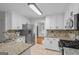 Well-lit kitchen features stainless steel appliances, granite countertops, and tile backsplash at 1048 Falls Brooke Dr, Conyers, GA 30094