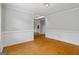 Open living room with hardwood floors and neutral paint provides a blank canvas for personal decoration at 1048 Falls Brooke Dr, Conyers, GA 30094
