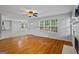 Open-concept living room with hardwood floors, a fireplace and connected kitchen at 1048 Falls Brooke Dr, Conyers, GA 30094