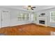 Spacious living room features hardwood floors, a fireplace and lots of natural light at 1048 Falls Brooke Dr, Conyers, GA 30094