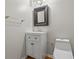 Stylish powder room features a framed mirror and a white vanity with storage at 1048 Falls Brooke Dr, Conyers, GA 30094