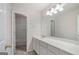Bathroom featuring large mirror, vanity, and doorway leading to shower with tub at 10775 Brunson Dr, Johns Creek, GA 30097