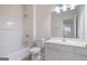 Well-lit bathroom with a shower-tub combination and vanity with a large mirror at 10775 Brunson Dr, Johns Creek, GA 30097