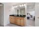 Bathroom featuring double sinks, granite countertop, and entry into main bedroom at 10775 Brunson Dr, Johns Creek, GA 30097