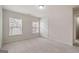 Bright bedroom with two windows, plush carpeting, and neutral walls at 10775 Brunson Dr, Johns Creek, GA 30097