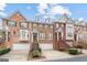 Well-maintained townhomes boast brick and stone exteriors with private garages at 10775 Brunson Dr, Johns Creek, GA 30097