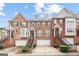 Charming townhome with brick and stone facade, and attached garages at 10775 Brunson Dr, Johns Creek, GA 30097