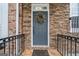 Inviting front door with stone surround and decorative wreath at 10775 Brunson Dr, Johns Creek, GA 30097