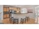 Charming kitchen features light wood cabinets, breakfast bar with seating, and stainless steel appliances at 10775 Brunson Dr, Johns Creek, GA 30097