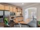 Bright kitchen showcases stainless steel appliances, including a built-in oven and microwave, with wood cabinets at 10775 Brunson Dr, Johns Creek, GA 30097