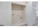 Laundry room with white tile flooring and connections for washer and dryer at 10775 Brunson Dr, Johns Creek, GA 30097